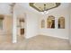 Open-concept living area with tile floors, arched accents, and views into other rooms at 1607 Tail Feather Dr, Kissimmee, FL 34746