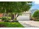 Beautiful home exterior featuring manicured landscaping, stone accents, and a two-car garage at 1607 Tail Feather Dr, Kissimmee, FL 34746