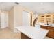 Open concept kitchen with center island, tile flooring, and access to the upstairs via stairs at 1607 Tail Feather Dr, Kissimmee, FL 34746