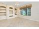 Comfortable living room with custom built-ins, ceiling fan, and large windows at 1607 Tail Feather Dr, Kissimmee, FL 34746