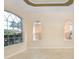 Bright living room featuring tile floors, arched windows, and decorative trim at 1607 Tail Feather Dr, Kissimmee, FL 34746