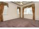 Main bedroom with brown carpet, neutral walls, ceiling fan and two windows with blinds and curtains at 1607 Tail Feather Dr, Kissimmee, FL 34746