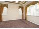 Main bedroom with brown carpet, neutral walls, ceiling fan and two windows with blinds and curtains at 1607 Tail Feather Dr, Kissimmee, FL 34746