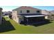A serene backyard featuring a screened lanai offering a peaceful outdoor living space at 1915 Acacia Dr, Kissimmee, FL 34758