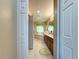 Hallway shot featuring bathroom with double sinks, bathtub, and tile flooring at 1915 Acacia Dr, Kissimmee, FL 34758