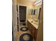 Bathroom featuring double sinks, neutral tile, and updated fixtures at 1915 Acacia Dr, Kissimmee, FL 34758