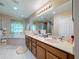 Spacious bathroom featuring double sinks, large mirror, and bathtub at 1915 Acacia Dr, Kissimmee, FL 34758
