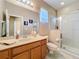 Bathroom featuring a walk-in shower, tile flooring, and vanity with ample counter space at 1915 Acacia Dr, Kissimmee, FL 34758