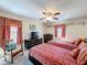 Bright bedroom with twin beds, decorated shelves, a rocking chair and natural light perfect for guests or Gathering at 1915 Acacia Dr, Kissimmee, FL 34758