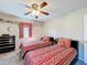 Bright bedroom with twin beds, decorated shelves, and ample natural light perfect for a guest room or ' space at 1915 Acacia Dr, Kissimmee, FL 34758