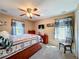 Bedroom with coastal decor has carpet, ceiling fan, and built in storage at 1915 Acacia Dr, Kissimmee, FL 34758