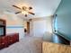 Bedroom with blue accents shows carpet, ceiling fan, closet, and lots of natural light at 1915 Acacia Dr, Kissimmee, FL 34758