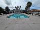 Large community pool with chairs, landscaping, and a community building at 1915 Acacia Dr, Kissimmee, FL 34758