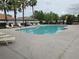 Large community pool with chairs, landscaping, and ample space for relaxing at 1915 Acacia Dr, Kissimmee, FL 34758