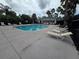 Large community pool with chairs, landscaping, and a nearby playground at 1915 Acacia Dr, Kissimmee, FL 34758