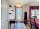Formal dining room with decorative rug, elegant light fixture and decorative display shelves at 1915 Acacia Dr, Kissimmee, FL 34758