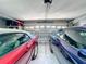 Spacious two car garage featuring epoxy flooring, insulated garage door, and storage shelves at 1915 Acacia Dr, Kissimmee, FL 34758