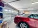 The garage offers ample space for vehicles and storage, featuring a well-maintained door and organized shelving at 1915 Acacia Dr, Kissimmee, FL 34758