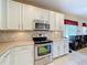 Stylish kitchen featuring stainless steel appliances and an efficient layout, perfect for cooking at 1915 Acacia Dr, Kissimmee, FL 34758