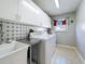 Bright laundry area includes washer, dryer, sink, and ample white cabinet storage at 1915 Acacia Dr, Kissimmee, FL 34758