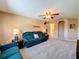 Neutral-toned living room features plush carpeting, ceiling fan, and comfortable seating; ready for relaxation at 1915 Acacia Dr, Kissimmee, FL 34758