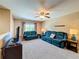 Comfortable living room featuring a ceiling fan, two couches, and carpeted flooring at 1915 Acacia Dr, Kissimmee, FL 34758