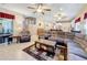 Open-concept living room with tile floors, ceiling fans, and a view of the stairs and kitchen at 1915 Acacia Dr, Kissimmee, FL 34758