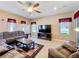 Bright living room with tile floors, recessed lighting, and a large television for entertaining at 1915 Acacia Dr, Kissimmee, FL 34758