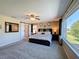 Beautifully appointed main bedroom with a large window, ceiling fan, and access to en-suite bathroom at 1915 Acacia Dr, Kissimmee, FL 34758