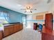 Bright office with natural light, built-in desk area, blue accent wall and neutral-colored carpet at 1915 Acacia Dr, Kissimmee, FL 34758