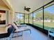 The screened porch is a perfect outdoor retreat with comfortable lounge chairs and scenic views of the well-maintained backyard at 1915 Acacia Dr, Kissimmee, FL 34758