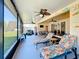 Spacious screened porch has lounge chairs, ceiling fans, dining area and outdoor kitchen perfect for relaxing and entertaining at 1915 Acacia Dr, Kissimmee, FL 34758