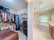 Spacious walk-in closet features ample storage and closet organizers, with the bathroom just beyond at 1915 Acacia Dr, Kissimmee, FL 34758