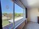 Bright main bedroom with large window overlooking green backyard at 1915 Acacia Dr, Kissimmee, FL 34758