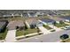 Aerial shot of a residential neighborhood showcasing similar homes with well-kept lawns and driveways at 219 Summerlin Loop, Haines City, FL 33844