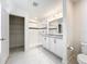 Modern bathroom with dual sinks, a tiled shower, and a walk-in closet at 219 Summerlin Loop, Haines City, FL 33844