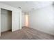 Clean bedroom features neutral carpet, closet, and door leading to hallway at 219 Summerlin Loop, Haines City, FL 33844