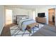 This spacious staged bedroom features a cozy bed, stylish decor, and ample natural light to create a relaxing atmosphere at 219 Summerlin Loop, Haines City, FL 33844