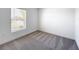 Bright bedroom with window and closet, showcasing neutral carpeting at 219 Summerlin Loop, Haines City, FL 33844