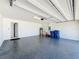 Clean and spacious two-car garage with epoxy flooring and ample storage space at 219 Summerlin Loop, Haines City, FL 33844