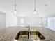Bright kitchen island with granite countertop and stainless steel sink, open to adjacent living area at 219 Summerlin Loop, Haines City, FL 33844