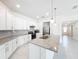 Spacious kitchen features white cabinets, granite counters, stainless steel appliances, and a large island at 219 Summerlin Loop, Haines City, FL 33844