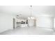 Open living space flows into a modern kitchen with island seating and bright, neutral decor at 219 Summerlin Loop, Haines City, FL 33844
