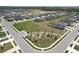 Aerial view of a neighborhood park featuring play equipment, landscaping, and walking paths at 219 Summerlin Loop, Haines City, FL 33844
