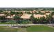 Aerial view of yellow homes overlooking golf course at 2502 Palm Tree Dr, Poinciana, FL 34759