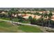 Aerial view of yellow homes overlooking golf course at 2502 Palm Tree Dr, Poinciana, FL 34759