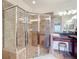 Bathroom with large, glass enclosed shower, and dark wood vanity with stool at 2502 Palm Tree Dr, Poinciana, FL 34759