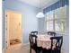 Bright breakfast nook featuring a round table and a window with sunlight coming through the blinds at 2502 Palm Tree Dr, Poinciana, FL 34759