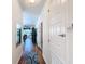 Bright hallway featuring wood floors and decor leading to an open living space with water views at 2502 Palm Tree Dr, Poinciana, FL 34759