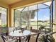Enjoy the outdoors in this screened lanai with a beautiful view, table and chairs for outdoor dining at 2502 Palm Tree Dr, Poinciana, FL 34759